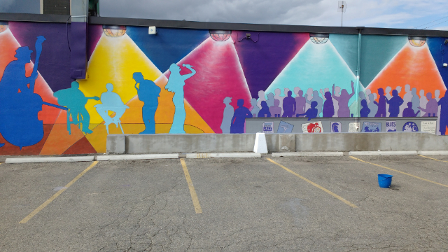 colourful mural of live music painted on wall